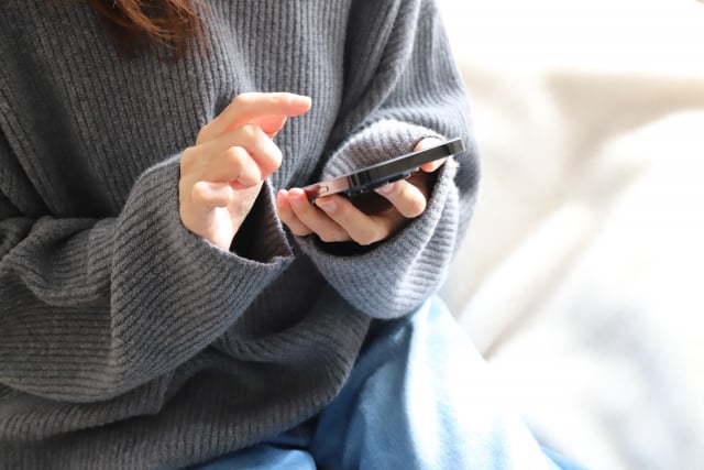 Woman operating a smartphone